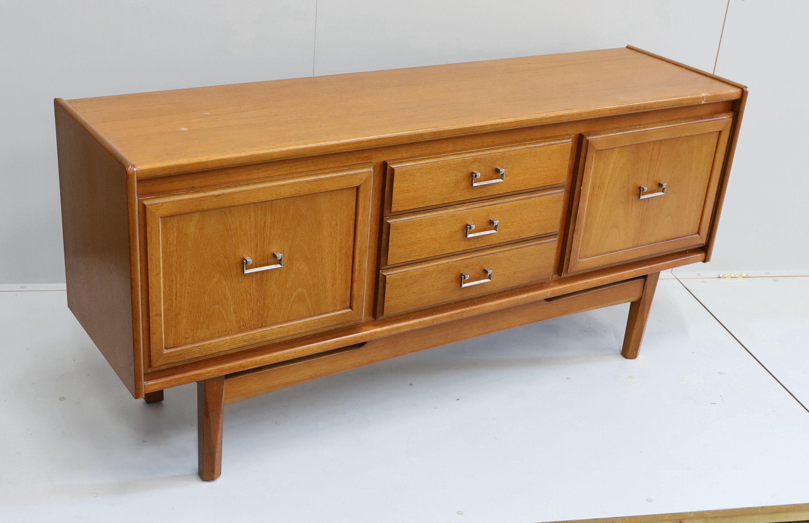 A mid century teak sideboard, bears William Lawrence label, width 163cm, depth 44cm, height 77cm